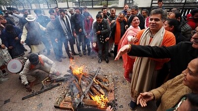 Ravinder Raina, President of Jammu and Kashmir Bharatiya Janata Party, marks Lohri festivities at the party office in Jammu. (ANI)