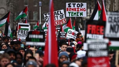 Pro-Palestinian activists and supporters wave flags and carry placards, including a "Stop Bombing Yemen" sign, during a National March for Palestine in central London on January 13, 2024. (AFP) Pro-Palestinian activists and supporters wave flags and carry placards, including a "Stop Bombing Yemen" sign, during a National March for Palestine in central London on January 13, 2024. (AFP)