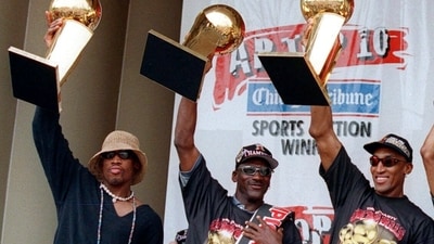 The Chicago Bulls players, from left, Dennis Rodman, left, Michael Jordan and Scottie Pippen, hoist three of the team's NBA Championship trophies during a celebration in Chicago's Grant Park on June 16, 1997. (AP) The Chicago Bulls players, from left, Dennis Rodman, left, Michael Jordan and Scottie Pippen, hoist three of the team's NBA Championship trophies during a celebration in Chicago's Grant Park on June 16, 1997. (AP)