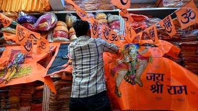 A shopkeeper looks for an order amidst flags and pennants depicting Hindu deities Lord Ram and Hanuman, at a shop in Mumbai. (AFP) A shopkeeper looks for an order amidst flags and pennants depicting Hindu deities Lord Ram and Hanuman, at a shop in Mumbai. (AFP)