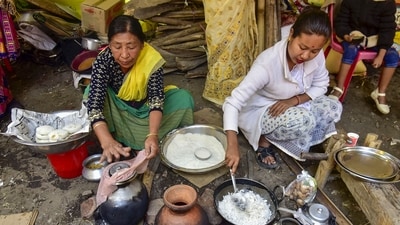 Women prepare 'pitha' (rice cake) ahead of the Bhogali Bihu festival in Guwahati. (PTI) Women prepare 'pitha' (rice cake) ahead of the Bhogali Bihu festival in Guwahati. (PTI)