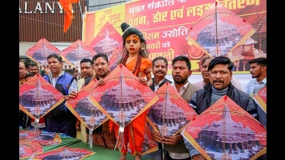 Sindhu Sena activists with a child dressed as Lord Ram show kites depicting pictures of Ayodhya's Ram Temple before their distribution ahead of the Makar Sankranti, in Bhopal. (PTI)