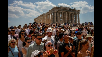 Tourists at the Acropolis, which is set to cap the number of visitors at 20,000 a day. (AP) Tourists at the Acropolis, which is set to cap the number of visitors at 20,000 a day. (AP)