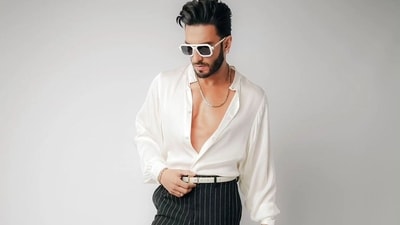 Ranveer Singh in a white satin shirt with puffed sleeves and pinstriped trousers (Photo: Instagram) Ranveer Singh in a white satin shirt with puffed sleeves and pinstriped trousers (Photo: Instagram)