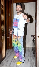Ranveer Singh in a funky rainbow-coloured distressed jeans and an oversized white graphic tee (Photo: Yogen Shah) Ranveer Singh in a funky rainbow-coloured distressed jeans and an oversized white graphic tee (Photo: Yogen Shah)
