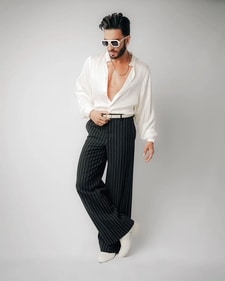 Ranveer Singh in a white satin shirt with puffed sleeves and pinstriped trousers (Photo: Instagram) Ranveer Singh in a white satin shirt with puffed sleeves and pinstriped trousers (Photo: Instagram)