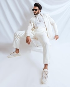 Ranveer Singh in a head-to-toe white look featuring a sleeveless turtleneck top, a light blazer and pant set (Photo: Instagram) Ranveer Singh in a head-to-toe white look featuring a sleeveless turtleneck top, a light blazer and pant set (Photo: Instagram)