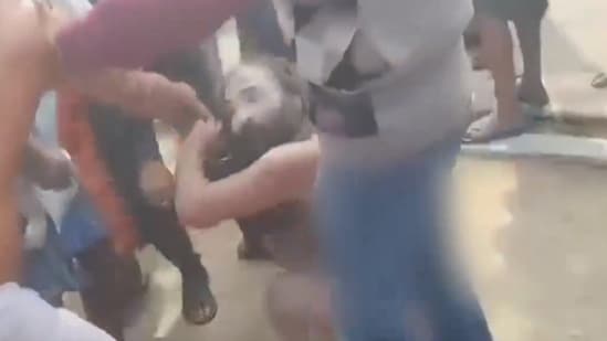 A group of sadhus being purportedly stripped and assaulted by a mob in Bengal's Purulia district.