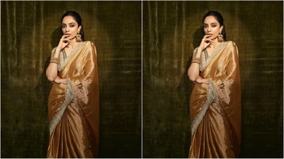 She paired her saree with a matching V-neck blouse featuring half sleeves, a brown embroidered border around the neckline and a traditional beige print all over to complete her golden saree. (Instagram/@sobhitad) She paired her saree with a matching V-neck blouse featuring half sleeves, a brown embroidered border around the neckline and a traditional beige print all over to complete her golden saree. (Instagram/@sobhitad)