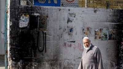 A Palestinian man walks on a street at the Nur Shams camp for Palestinian refugees, where Israeli raids have been conducted, near the occupied West Bank city of Tulkarm on January 8, 2024. (AFP) A Palestinian man walks on a street at the Nur Shams camp for Palestinian refugees, where Israeli raids have been conducted, near the occupied West Bank city of Tulkarm on January 8, 2024. (AFP)