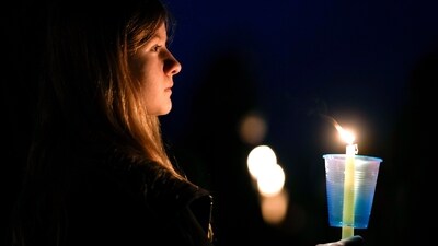 FILE - A local resident prays during a candlelight vigil following a shooting at Perry High School, Jan. 4, 2024, in Perry, Iowa. (AP) FILE - A local resident prays during a candlelight vigil following a shooting at Perry High School, Jan. 4, 2024, in Perry, Iowa. (AP)