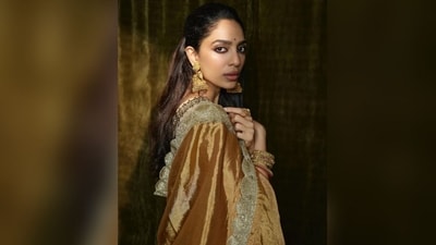 Sobhita styled her long, lush locks into soft curls and pinned up the section, leaving the rest loose, to cascade beautifully down her shoulders, complementing her saree look perfectly. (Instagram/@sobhitad) Sobhita styled her long, lush locks into soft curls and pinned up the section, leaving the rest loose, to cascade beautifully down her shoulders, complementing her saree look perfectly. (Instagram/@sobhitad)