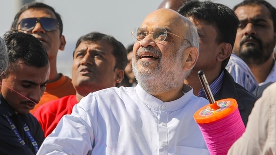 Union Home Minister Amit Shah engages in kite-flying festivities during the Makar Sankranti celebration in Ahmedabad on Sunday.(PTI)