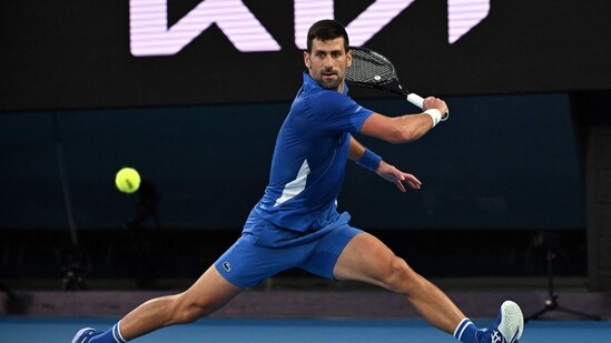 Serbia's Novak Djokovic hits a return against Croatia's Dino Prizmic during their men's singles match on day one of the Australian Open tennis tournament in Melbourne (AFP)