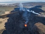 Iceland volcano updates: An areal view of the lava field with the main active vent, the town of Grindavik is in the background, Iceland. Iceland volcano updates: An areal view of the lava field with the main active vent, the town of Grindavik is in the background, Iceland.