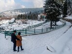 Tangmarg: Tourists walk on a snow-covered road after a fresh snowfall, in Tangmarg, Jammu and Kashmir, Sunday, Dec. 17, 2023. (PTI Photo)(PTI12_17_2023_000224A) Tangmarg: Tourists walk on a snow-covered road after a fresh snowfall, in Tangmarg, Jammu and Kashmir, Sunday, Dec. 17, 2023. (PTI Photo)(PTI12_17_2023_000224A)