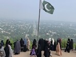 A Pakistani flag flies on a lookout as women take in the view of Islamabad, Pakistan. (AP Photo/Image used only for representation)