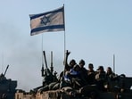 A picture taken from the Israeli border with Gaza shows Israeli soldiers in an armoured vehicle convoy returning from the Palestinian territory on January 15, 2024, amid ongoing battles between Israel and the Palestinian Hamas militant group. 