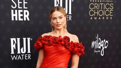 <p>Australian actor Margot Robbie arrives for show in a red floral gown. She was nominated in the Best Actress category for Barbie. She lost the award to Emma Stone for Poor Things.</p> (AFP)
