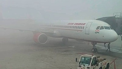 Fog drapes an aircraft at the Delhi airport on Sunday morning. (ANI) Fog drapes an aircraft at the Delhi airport on Sunday morning. (ANI)