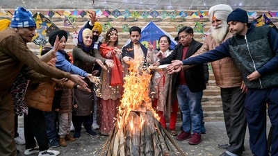 People offer puffed rice, peanuts and popcorn to a bonfire on the occasion of Lohri, the Hindu Sikh festival of spring in Amritsar. (AFP) People offer puffed rice, peanuts and popcorn to a bonfire on the occasion of Lohri, the Hindu Sikh festival of spring in Amritsar. (AFP)