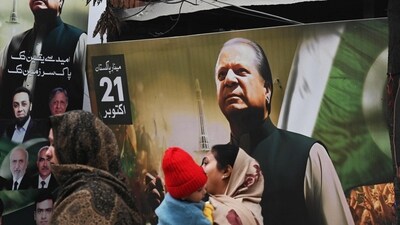 Pakistan elections: People walk past a banner of the Pakistan Muslim League Nawaz (PML N) party with an image of former prime minister of Pakistan and candidate Nawaz Sharif in Lahore. (AFP) Pakistan elections: People walk past a banner of the Pakistan Muslim League Nawaz (PML N) party with an image of former prime minister of Pakistan and candidate Nawaz Sharif in Lahore. (AFP)
