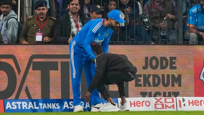 The pitch invader managed to get to Virat Kohli, touch his feet and hug him before being taken off the field. (PTI) The pitch invader managed to get to Virat Kohli, touch his feet and hug him before being taken off the field. (PTI)