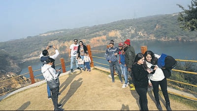 Visitors at Neeli Jheel at the Asola Bhatti wildlife sanctuary in New Delhi on Sunday. (Arvind Yadav/HT Photo) Visitors at Neeli Jheel at the Asola Bhatti wildlife sanctuary in New Delhi on Sunday. (Arvind Yadav/HT Photo)