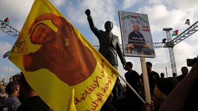 Protesters hold up portraits of Palestinian leader and prominent prisoner Marwan Barghouti in front of a statue of Nelson Mandela in the West Bank city of Ramallah. (AFP) Protesters hold up portraits of Palestinian leader and prominent prisoner Marwan Barghouti in front of a statue of Nelson Mandela in the West Bank city of Ramallah. (AFP)