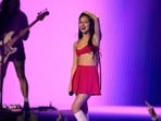 Olivia Rodrigo performs during the MTV Video Music Awards in a stylish pink bralette, matching mini skirt, white heeled boots, minimal glam, and open tresses.&nbsp;