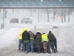 Good Samaritans help a driver out after his rear-wheel drive vehicle got stranded on Rosa L. Parks Blvd. after a winter storm in Nashville, Tenn., Monday, Jan. 15, 2024. (Denny Simmons/The Tennessean via AP) Good Samaritans help a driver out after his rear-wheel drive vehicle got stranded on Rosa L. Parks Blvd. after a winter storm in Nashville, Tenn., Monday, Jan. 15, 2024. (Denny Simmons/The Tennessean via AP)