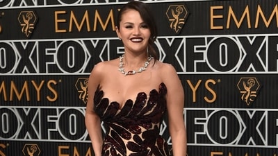 Selena Gomez stunned on the red carpet at the 75th Emmy Awards in a stunning see-through gown embellished with a shimmering brown floral detail all over. She paired it with a silver statement necklace for a glamorous look. With bold lipstick and her hair tied up, she oozed gothic princess vibes. (Richard Shotwell/Invision/AP)