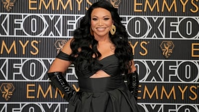 Tisha Campbell arrived at the 75th Primetime Emmy Awards in a stunning black gown. Her dress features an off-the-shoulder neckline, a cut-out pattern at the bust and a skirt at the bottom. Styled with shiny black elbow-length gloves and a pair of gold statement hoop earrings, she turned heads. (AP Photo/Ashley Landis)