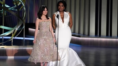 Jenna Ortega looked stunning in a strapless Dior gown featuring a molded skirt adorned with an elegant pastel pattern of blossom applique. (AP)