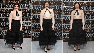 Kathryn Hahn attended the Emmys in a classic white blouse and black skirt. She wore a Spring-Summer 2019 Dior Haute Couture cocktail ensemble featuring an ivory organza bib-front shirt and black embroidered skirt. She styled the outfit with black heels, brick-red lips, and jewellery from Sophie Bille Brahe. (AFP, AP) Kathryn Hahn attended the Emmys in a classic white blouse and black skirt. She wore a Spring-Summer 2019 Dior Haute Couture cocktail ensemble featuring an ivory organza bib-front shirt and black embroidered skirt. She styled the outfit with black heels, brick-red lips, and jewellery from Sophie Bille Brahe. (AFP, AP)