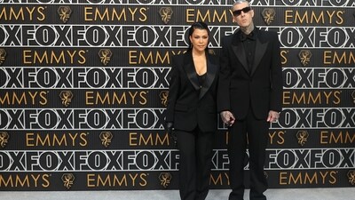Kourtney Kardashian and Travis Barker attend the 75th Primetime Emmy Awards, and the couple's all-black look is a fashion statement. Kourtney wore a black bralette top paired with a black blazer and fitted trousers. Meanwhile, Travis wore a three-piece black suit completed with a black bow and matching rectangular sunglasses. (REUTERS/Aude Guerrucci)