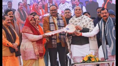 Defence minister Rajnath Singh with a beneficiary of a government scheme in the state capital on Tuesday. (Sourced)