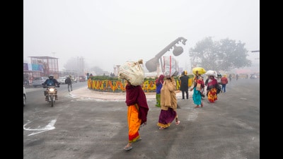 Devotees arrive at Lata Mangeshkar Chowk on a cold winter morning ahead of the consecration ceremony of Shri Ram Janmabhoomi Temple, in Ayodhya, Tuesday. (PTI)
