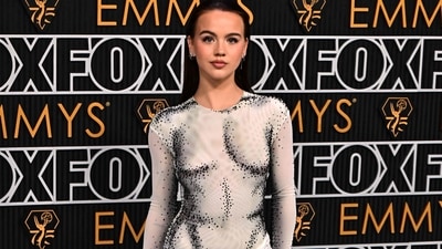 Emma Brooks McAllister hit the red carpet at the Emmy Awards in a grey sheer gown that hugged her body perfectly and accentuated her curves. Adorned with black crystal embellishments, her outfit was a total showstopper. She completed the look with bold eye make-up, rosy cheeks, pink lipstick and slicked back hair. (Photo by Frederic J. Brown / AFP)