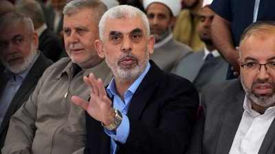 Israel-Hamas War: Yahya Sinwar, head of Hamas in Gaza, greets his supporters upon his arrival at a meeting in a hall on the sea side of Gaza City. (AP)