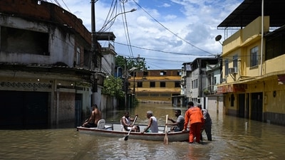 Brazil Floods: Locals sail a boat in a flooded area of the Lote XV community in Belford Roxo, Rio de Janeiro State, Brazi. (AFP) Brazil Floods: Locals sail a boat in a flooded area of the Lote XV community in Belford Roxo, Rio de Janeiro State, Brazi. (AFP)