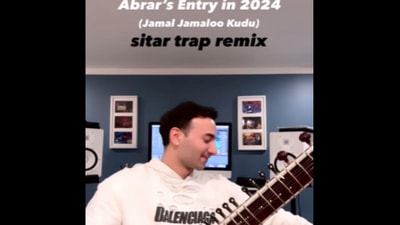 Man playing Jamal Kudu on sitar. Man playing Jamal Kudu on sitar.