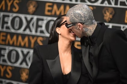 Kourtney Kardashian and Travis Barker shared a kiss on the red-carpet of the 75th Primetime Emmy Awards on Monday at the Peacock Theatre in Los Angeles. (Richard Shotwell/Invision/AP) Kourtney Kardashian and Travis Barker shared a kiss on the red-carpet of the 75th Primetime Emmy Awards on Monday at the Peacock Theatre in Los Angeles. (Richard Shotwell/Invision/AP)