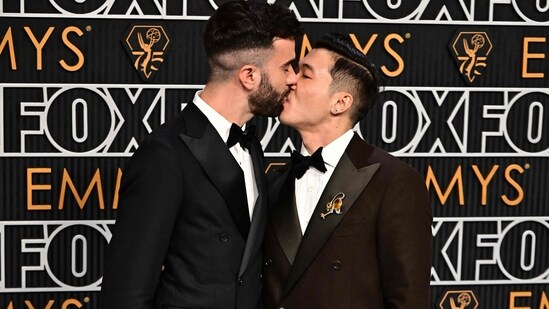 Actors Joel Kim Booster and John Michael Kelly arrive for the 75th Emmy Awards at the Peacock Theatre at L.A. Live in Los Angeles on January 15, 2024.(Photo by Frederic J. Brown / AFP))