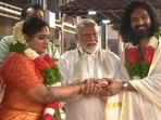 PM Modi posing for the camera with the newlywed couple. PM Modi posing for the camera with the newlywed couple.