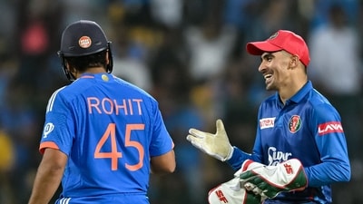 Afghanistan's Rahmanullah Gurbaz talks with India's captain Rohit Sharma (L) during the super over (AFP) Afghanistan's Rahmanullah Gurbaz talks with India's captain Rohit Sharma (L) during the super over (AFP)