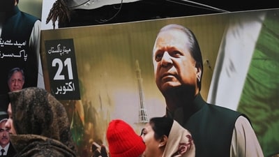 Pakistan elections: People walk past a banner of the Pakistan Muslim League Nawaz (PML N) party with an image of former prime minister of Pakistan and candidate Nawaz Sharif in Lahore. (AFP) Pakistan elections: People walk past a banner of the Pakistan Muslim League Nawaz (PML N) party with an image of former prime minister of Pakistan and candidate Nawaz Sharif in Lahore. (AFP)