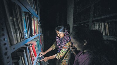 People look for books using mobile phone torch at Hardayal library. (HT Photo) People look for books using mobile phone torch at Hardayal library. (HT Photo)