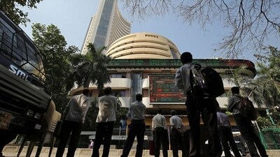 People look at a screen displaying the Sensex results on the facade of the Bombay Stock Exchange (BSE) building in Mumbai. (REUTERS)
