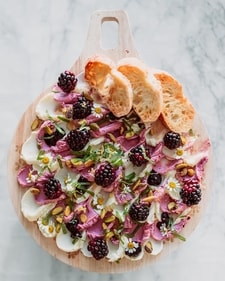 Butter Board with two kinds of butters and topped with berries, edibles flowers, nuts and seeds (Instagram) Butter Board with two kinds of butters and topped with berries, edibles flowers, nuts and seeds (Instagram)